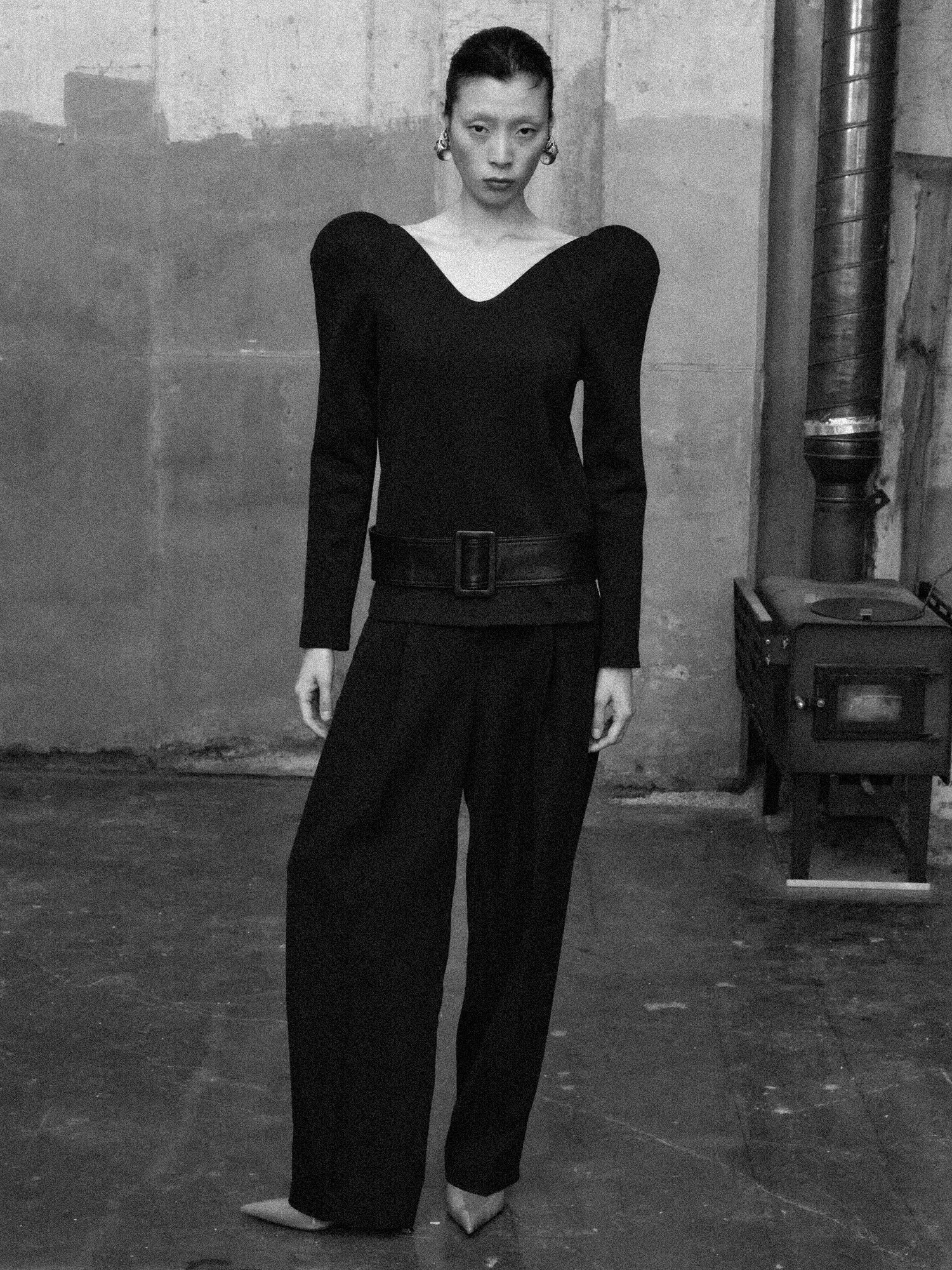 black sculptural blouse with curved neckline and molded structured shoulders-b&w